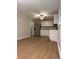 An open kitchen with stainless steel appliances, white cabinets and a dining area at 882 Campbell Rd, Covington, GA 30014