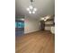 Bright living room featuring hardwood floors, modern lighting, and a view into the open kitchen at 882 Campbell Rd, Covington, GA 30014