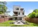Modern home boasts landscaped backyard featuring a fire pit and stone bench seating at 1102 Sanders Se Ave, Atlanta, GA 30316