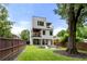 Expansive backyard featuring lush grass, a stone patio, and a modern home with multiple balconies at 1102 Sanders Se Ave, Atlanta, GA 30316