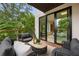 Balcony with comfortable seating and wooded views, accessible through sliding glass doors from the main bedroom at 1102 Sanders Se Ave, Atlanta, GA 30316