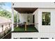 The covered balcony features comfortable seating, artificial turf, and stylish wood railing at 1102 Sanders Se Ave, Atlanta, GA 30316