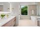 Modern bathroom with a sleek soaking tub, stylish fixtures, and a large window offering natural light at 1102 Sanders Se Ave, Atlanta, GA 30316