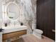 Modern powder room featuring custom vanity, lighting, and marble accent wall at 1102 Sanders Se Ave, Atlanta, GA 30316