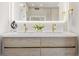 Bathroom vanity boasts double sinks, wooden cabinets, modern fixtures, and an elegant mirror at 1102 Sanders Se Ave, Atlanta, GA 30316