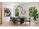 Bright dining room featuring stylish light fixture, art and views of outdoor greenery at 1102 Sanders Se Ave, Atlanta, GA 30316