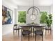 Bright dining room featuring stylish light fixture, art and views of outdoor greenery at 1102 Sanders Se Ave, Atlanta, GA 30316
