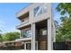 Modern home with a sleek facade, multiple balconies, and a glass garage door enhancing its curb appeal at 1102 Sanders Se Ave, Atlanta, GA 30316