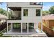 Modern three-story home featuring a balcony on the second floor and a concrete patio at 1102 Sanders Se Ave, Atlanta, GA 30316