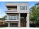 Striking modern home featuring clean lines, multiple balconies, and a sleek design with a glass garage door at 1102 Sanders Se Ave, Atlanta, GA 30316