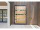 Contemporary wood and glass front door adds modern flair to home's exterior with vertical wood accent siding at 1102 Sanders Se Ave, Atlanta, GA 30316