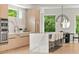 Modern kitchen featuring stone countertops, a large center island with seating, and stainless steel appliances at 1102 Sanders Se Ave, Atlanta, GA 30316