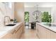 Modern kitchen featuring stone countertops, stainless steel faucet, and an adjacent dining area at 1102 Sanders Se Ave, Atlanta, GA 30316