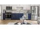 Modern kitchen with stainless steel appliances, white upper cabinets, and contrasting blue lower cabinets at 1102 Sanders Se Ave, Atlanta, GA 30316