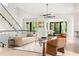 Bright, modern living room with a sleek staircase, stylish furniture, and large windows showcasing the outdoor view at 1102 Sanders Se Ave, Atlanta, GA 30316