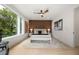 Bright main bedroom featuring wood accent wall, ceiling fan, and large windows with natural light at 1102 Sanders Se Ave, Atlanta, GA 30316