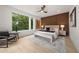 Bright main bedroom featuring wood accent wall, ceiling fan, and large windows with natural light at 1102 Sanders Se Ave, Atlanta, GA 30316