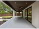 Covered outdoor patio includes fan, multiple glass doors, and view of backyard at 1102 Sanders Se Ave, Atlanta, GA 30316