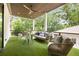 Covered outdoor patio with ceiling fan, modern furniture, and green turf at 1102 Sanders Se Ave, Atlanta, GA 30316