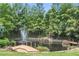 Picturesque pond with a fountain, waterfall and bridge surrounded by lush landscaping for a serene view at 1102 Sanders Se Ave, Atlanta, GA 30316