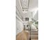 Elegant staircase with glass railings and modern lighting fixture creating a stunning focal point in the home at 1102 Sanders Se Ave, Atlanta, GA 30316