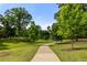 Scenic walking path through lush greenery with mature trees offering a tranquil outdoor experience at 1102 Sanders Se Ave, Atlanta, GA 30316