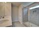 Bright bathroom featuring double vanity sinks and a glass-enclosed shower at 568 Teversham Dr, Mcdonough, GA 30253