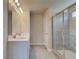 Well-lit bathroom featuring double vanity sinks and a glass-enclosed shower at 568 Teversham Dr, Mcdonough, GA 30253