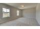 Spacious bedroom with plush carpeting and two windows for lots of natural light at 568 Teversham Dr, Mcdonough, GA 30253