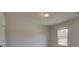 Cozy bedroom with neutral walls, natural lighting, and a view of the outside at 568 Teversham Dr, Mcdonough, GA 30253