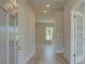 Bright foyer with light wood floors, neutral walls, and a view into adjacent rooms at 568 Teversham Dr, Mcdonough, GA 30253