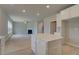 Bright kitchen view into the living room featuring a central island and lots of cabinet space at 568 Teversham Dr, Mcdonough, GA 30253