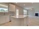 Modern kitchen with stainless steel appliances and center island, looking out towards the living room at 568 Teversham Dr, Mcdonough, GA 30253