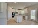 Well-lit kitchen showcasing a center island, stainless steel appliances, and sleek white cabinetry at 568 Teversham Dr, Mcdonough, GA 30253