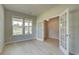 Home office with light walls, hardwood floors, and French doors at 568 Teversham Dr, Mcdonough, GA 30253