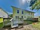 The backyard includes a wooden deck, green grass, and a bright blue sky at 1236 Pinedale Nw Cir, Conyers, GA 30012