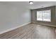 This bedroom features neutral walls, wood-look flooring, and a bright window providing ample natural light at 1236 Pinedale Nw Cir, Conyers, GA 30012