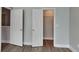 This bedroom features neutral walls, wood-look flooring, and two white doors at 1236 Pinedale Nw Cir, Conyers, GA 30012