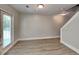 Bright living room features wood-look flooring, walkout to deck, and stairway access at 1236 Pinedale Nw Cir, Conyers, GA 30012