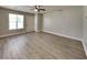 Spacious living room with wood-look floors, neutral paint, and ample natural light at 1236 Pinedale Nw Cir, Conyers, GA 30012