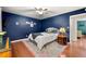 Well-lit blue bedroom with ceiling fan, hardwood floors, and ample space at 3149 Buford Ne Hwy # 2, Atlanta, GA 30329