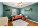 Cozy green bedroom with a ceiling fan and bright hardwood floors, ideal for children at 3149 Buford Ne Hwy # 2, Atlanta, GA 30329