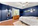 Blue bedroom with a ceiling fan, natural light, and warm hardwood floors at 3149 Buford Ne Hwy # 2, Atlanta, GA 30329