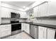 Well-equipped kitchen with stainless steel appliances, granite countertops, and white cabinetry at 3149 Buford Ne Hwy # 2, Atlanta, GA 30329