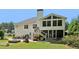 Expansive backyard featuring patio, fire pit and an enclosed porch area, perfect for outdoor entertaining at 4046 Water Hole Ct, Douglasville, GA 30135