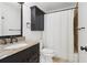 Cozy bathroom with a granite vanity, dark cabinetry, and tiled shower with curtain at 4046 Water Hole Ct, Douglasville, GA 30135