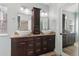 Bathroom with double vanity sinks, wood cabinets, granite countertops, and a large mirror at 4046 Water Hole Ct, Douglasville, GA 30135