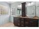 Bathroom with double vanity sinks, wood cabinets, granite countertops, and a window at 4046 Water Hole Ct, Douglasville, GA 30135