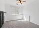 Bedroom with neutral carpet, ceiling fan, and window with blinds offering ample natural light at 4046 Water Hole Ct, Douglasville, GA 30135
