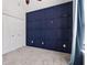 Spacious bedroom showcasing a blue accent wall, plush carpet, and double door closet at 4046 Water Hole Ct, Douglasville, GA 30135